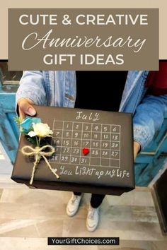 a person holding a box with a calendar on it and the words cute & creative anniversary gift ideas