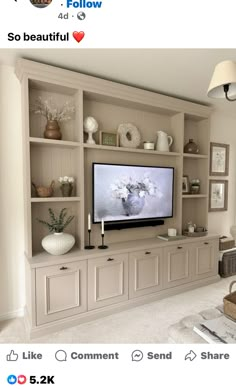 an entertainment center with built - in shelving and vases