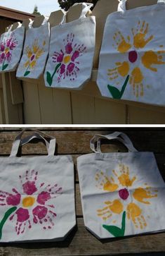 two bags with handprints on them, one is white and the other is pink