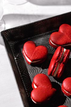 heart shaped red velvet cookies on a black tray