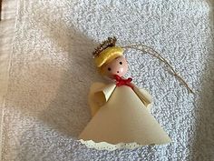 an ornament shaped like a princess on a towel