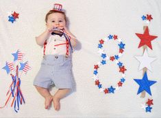 a baby is laying on the ground with patriotic decorations