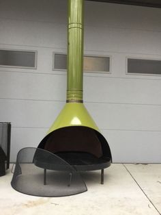 a green fire place sitting in front of a garage