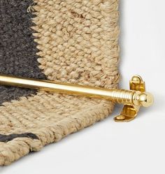 a close up of a gold handle on a rug