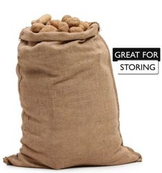 a bag filled with potatoes sitting on top of a white table next to a sign that says great for storing