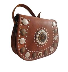 Shoulder bag, brown color, boho style, with rivets and rhinestones, with handle to hang from the shoulder, handmade Brown Satchel Saddle Bag For Festivals, Brown Leather Saddle Bag For Festival, Brown Leather Shoulder Bag For Festivals, Bohemian Brown Shoulder Bag With Leather Backing, Hand Tooled Brown Shoulder Bag For Festivals, Bohemian Brown Saddle Bag For Festivals, Brown Crossbody Shoulder Bag For Festival, Brown Crossbody Saddle Bag For Festival, Brown Bohemian Shoulder Bag With Leather Backing