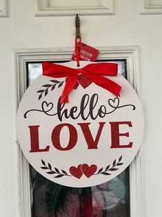 "11 in. Round Valentine's Day sentiment sign. Easy to hang in your home, office, business and more. Beautiful Door Hanger says \"Hello Love\" and features a pink satin bow at the top.  Colors: Red, White, Black, Pink Material: MDF Height: 11.00 in" Heart Door Hanger, Hello Love, Door Hanger Wreath, Hanger Wreath, Holiday Red, Beautiful Doors, Office Business, Sign Wall, Satin Bow