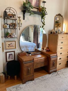 a bedroom with a dresser and mirror in it