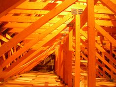 the inside of an unfinished building with wooden beams