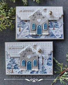 two cards with blue and white designs on them, one has a house in the middle