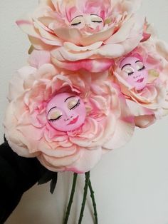 a bouquet of pink flowers with an image of a woman's face on it