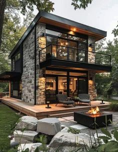 a modern house built in the woods with stone walls and flooring, an outdoor fire pit