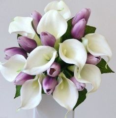 white and purple flowers are in a vase