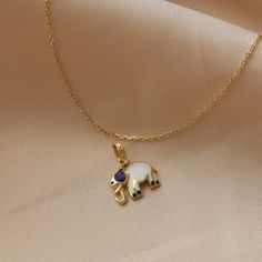 14K Real Gold Necklace Dark Blue White Enamel Elephant Pendant Handmade Minimalist Animal Design Dainty Christmas Elegance Gift for Women ⓂMaterials & Specifications : Necklace Chain Lengths : 42 cm (16.5 in) 44 cm (17.3 in) 46 cm (18.1 in) 48 cm (18.8 in) Elephant Pendant Width : 1.1 cm (0.43 in) Elephant Pendant Length : 0.9 cm (0.35 in) Handmade Item Special Design Blue Pendant Necklace For Celebration, Elegant Yellow Gold Enamel Charm Necklaces, Handmade Yellow Gold Elegant Charm Necklace, Elegant Handmade Yellow Gold Charm Necklace, Elegant Enamel Gemstone Necklaces, Elegant Enamel Necklaces With Gemstone, Elegant Festive Enamel Jewelry, Elegant Enamel Necklace With Hallmark, Elegant Jewelry With Charms For Celebration