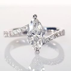 an oval cut diamond ring with pave set shoulders