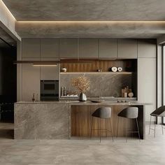 a modern kitchen with marble counter tops and bar stools