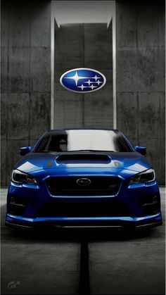 a blue subarun car parked in front of a building with a ford emblem on it