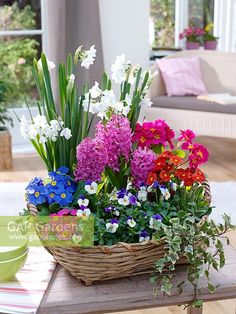 a basket filled with flowers sitting on top of a table