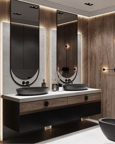 a modern bathroom with two sinks and mirrors