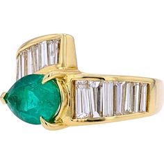 an emerald and diamond ring with baguets set in yellow gold plated silver