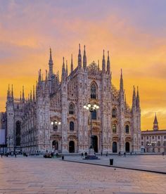 the cathedral is lit up at sunset in europe