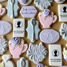 decorated cookies are arranged on a table with labels for different types of items and designs