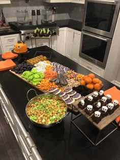 a kitchen counter topped with lots of different types of foods and desserts on top of it