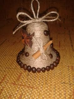 a small bell made out of twine and wood beads