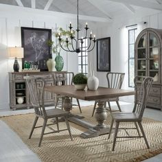 a dining room table with chairs and a chandelier