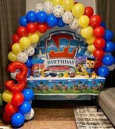 a birthday party with balloons and decorations in the shape of numbers, including an arch