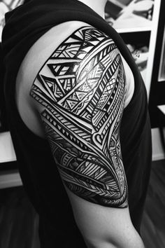 Person's upper arm adorned with an intricate black tribal tattoo. Meaningful Tattoo, Nordic Tattoo, Adinkra Symbols