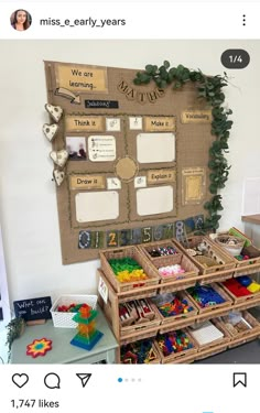 a bulletin board with lots of things on it and some toys in the bins