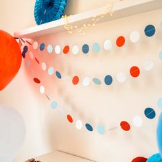 a birthday party with balloons, streamers and cake