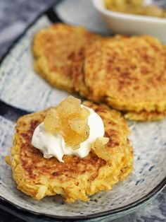 two pancakes on a plate with whipped cream