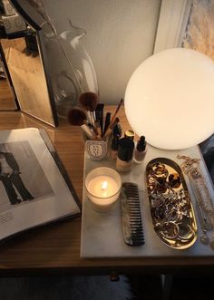 a table topped with lots of different types of makeup and hair brushes on top of it