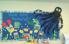 a bulletin board with an octopus and sea animals on it that says dive into reading