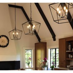 a kitchen with wooden cabinets and lights hanging from the ceiling