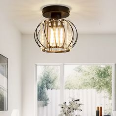 a dining room table and chairs with a light fixture hanging from the ceiling over it