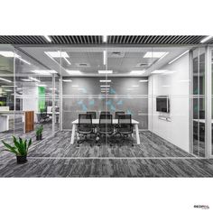 an empty conference room with glass walls and plants in the center, surrounded by office furniture