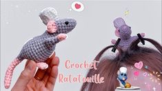 a crochet ratatoulie is being held up by a woman's hand