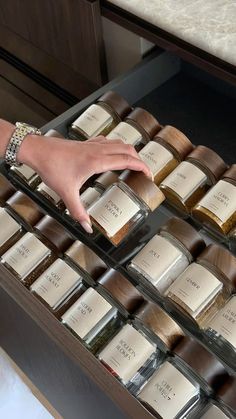 a person reaching for spices in a drawer