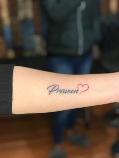 a woman's arm with a tattoo that says heaven and two hearts on it