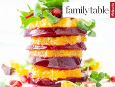 a stack of fruit and veggies with the words family table on top of it