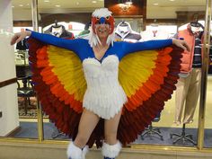 a woman dressed as a bird is posing for the camera