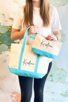 a woman holding two bags with writing on them