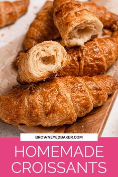 some croissants are on a cutting board and ready to be eaten by someone