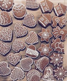 many different types of cookies are on a sheet of wax paper and ready to be decorated