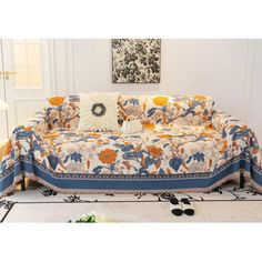 a couch covered in an orange and blue floral print