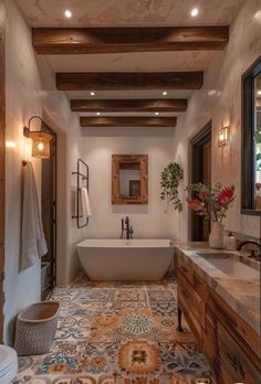 a bathroom with a bathtub, toilet and sink in it's center area