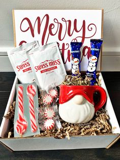 a christmas gift box filled with candy, marshmallows and other holiday treats